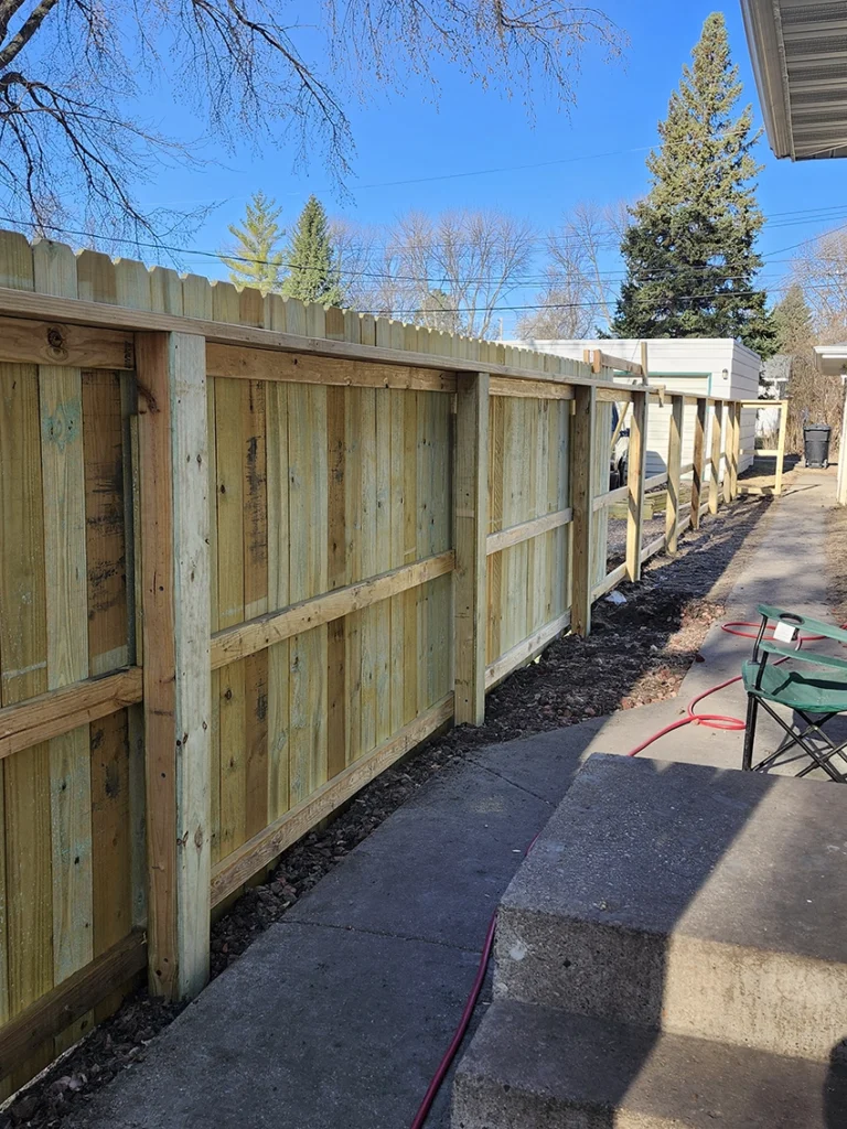 Wood fence installation project by professional contractors in Grand Forks ND