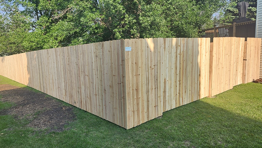 Backyard wood fence project completed by local contractors in Grand Forks ND
